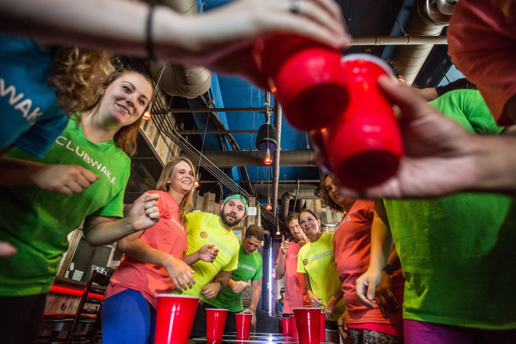 A group of adults playing drinking games