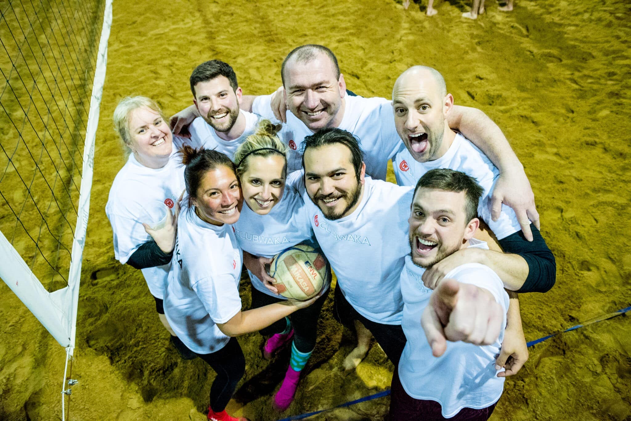 A group of adults playing volleyball